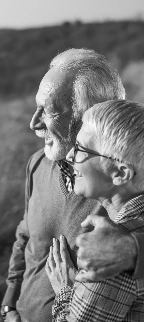older couple looking off towards sunset in B&W